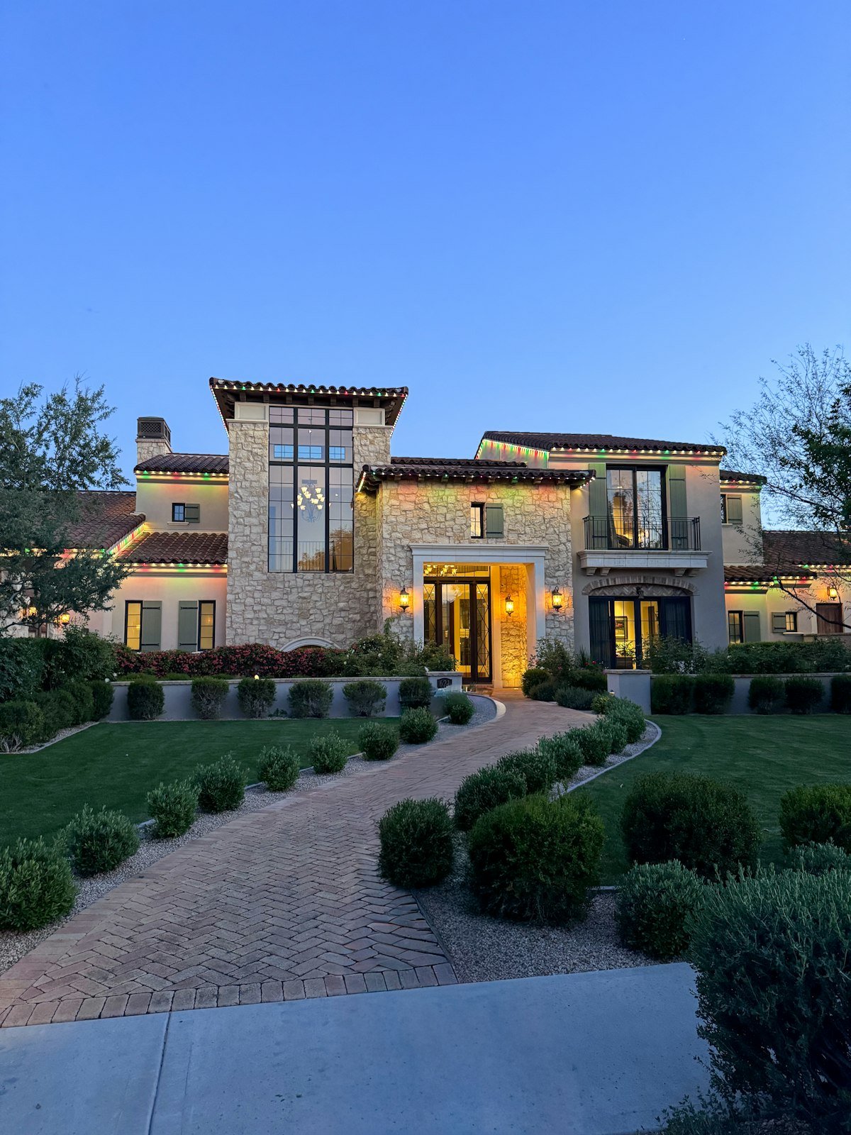 Modern luxury custom home with manicured landscaping built by a design-build firm