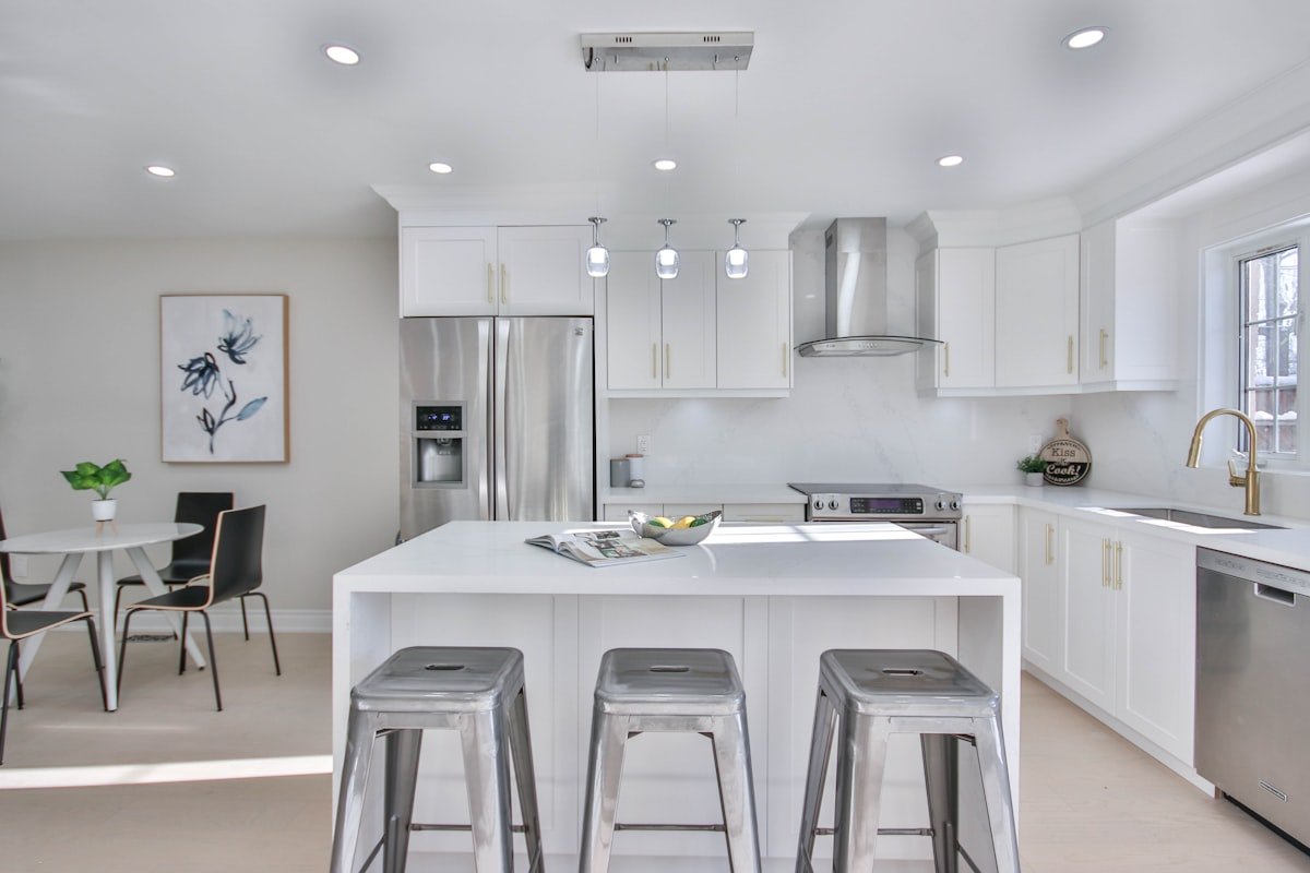 Modern kitchen with center island and bar stools showing premium kitchen remodel