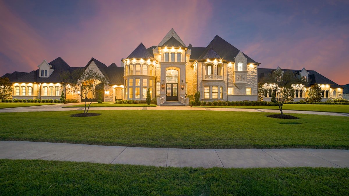 Premium custom home with architectural lighting at dusk