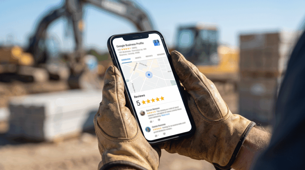 a contractor's hands holding a smartphone, setting up or reviewing a Google Business Profile